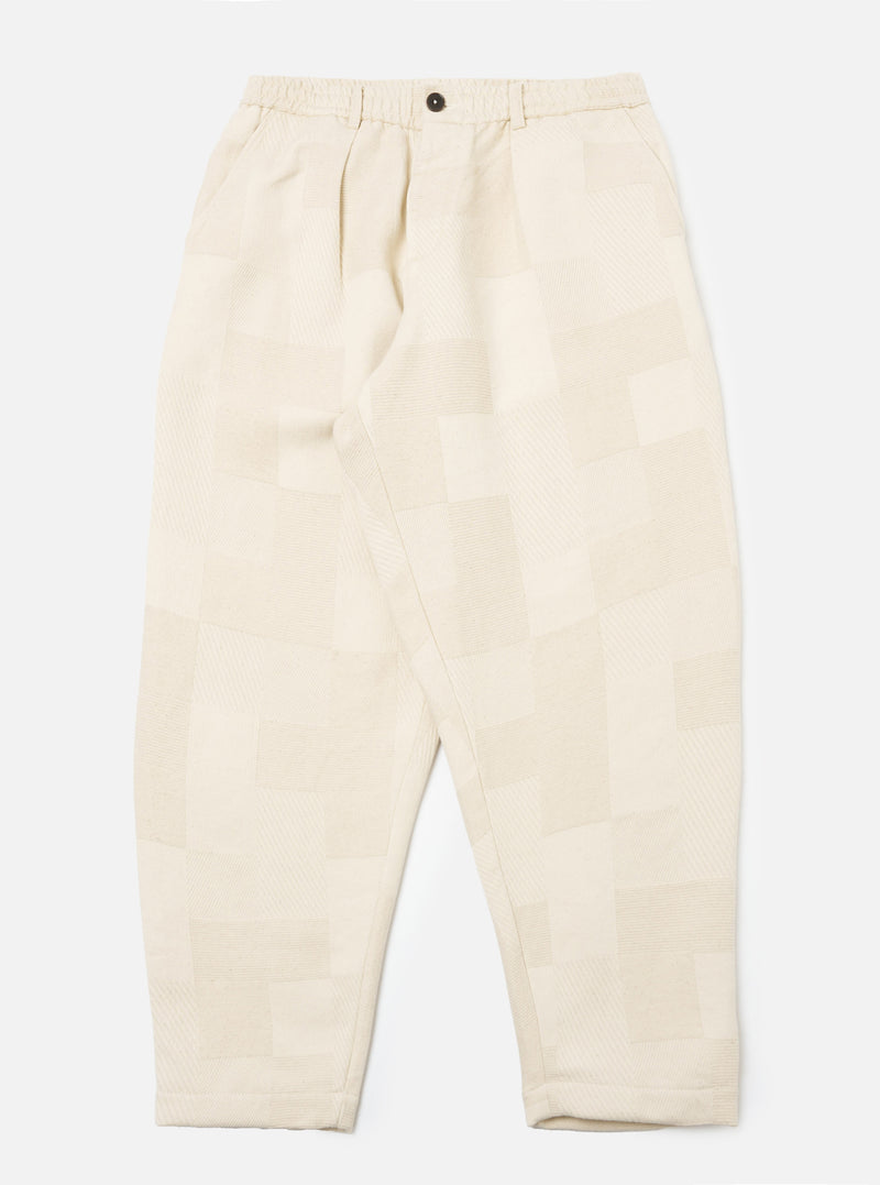 Ecru Patchwork Weave Cotton Pleated Track Pant on a white background. The pants feature a patchwork design and a relaxed fit.