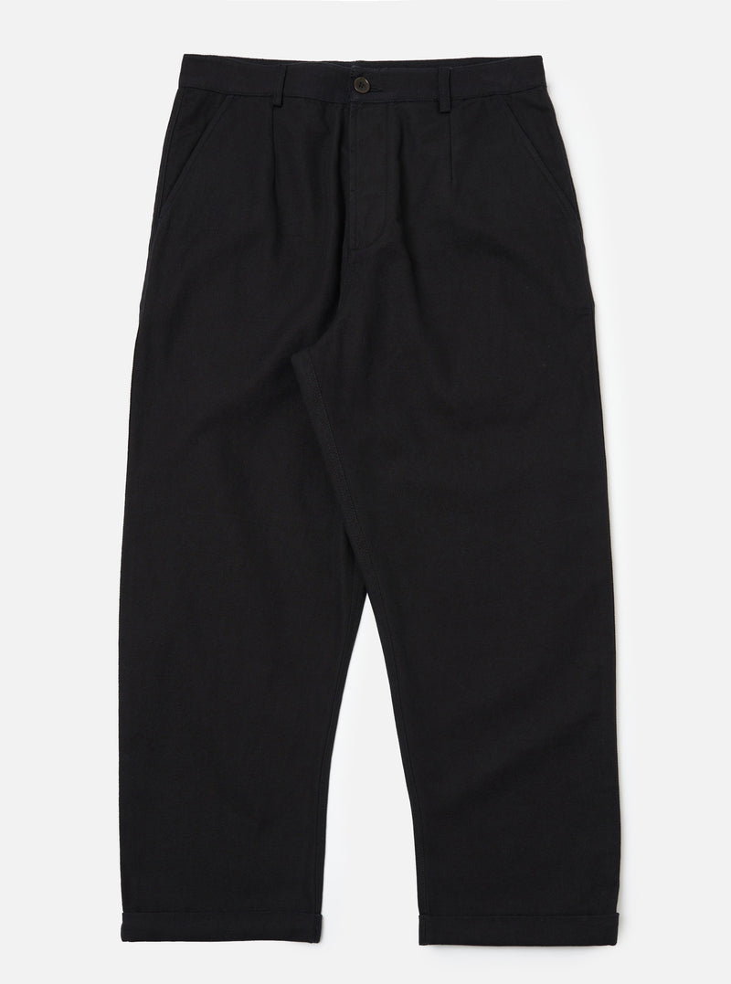 Studio shot of Black Organic Canvas Super Chino pants. The canvas material has a relaxed fit. The background is a clean, bright white.