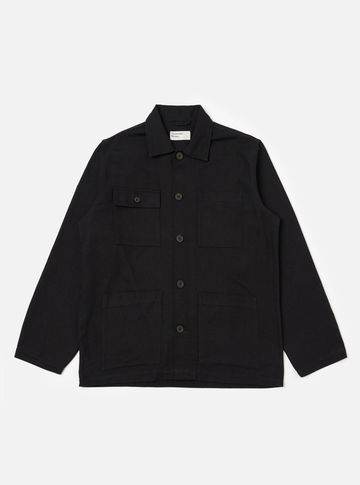 The Black Organic Canvas Dockside Overshirt is laid flat on a white background. The overshirt has a collared neck, button closure, and four pockets.