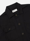 Close-up of the Black Organic Canvas Dockside Overshirt on a white background. The shirt has a button-down front and two chest pockets.
