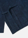 Close-up of the Black/Indigo Denim Camo Kyoto Work Jacket on a white surface. The jacket features a unique camo pattern in indigo and black denim.