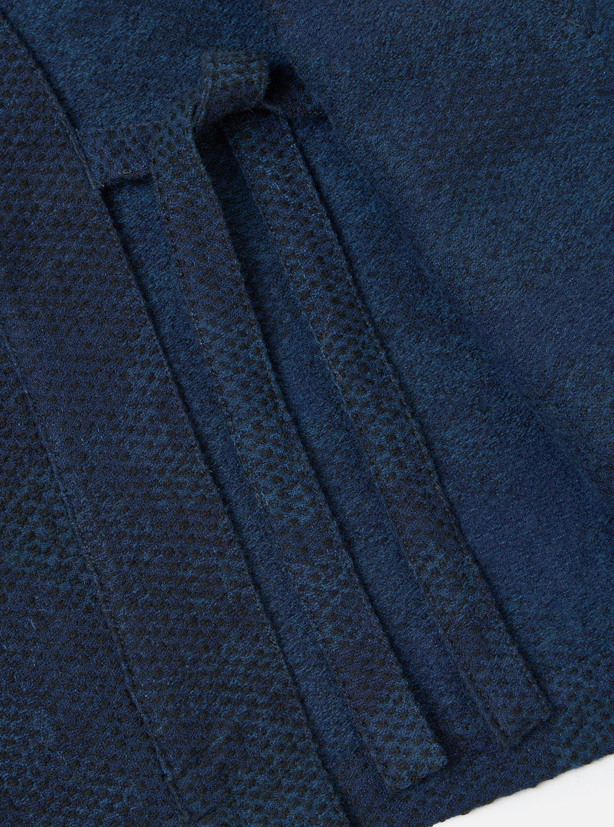 Close-up of the Black/Indigo Denim Camo Kyoto Work Jacket showing the fabric texture and pocket detail. The jacket is displayed on a flat surface.