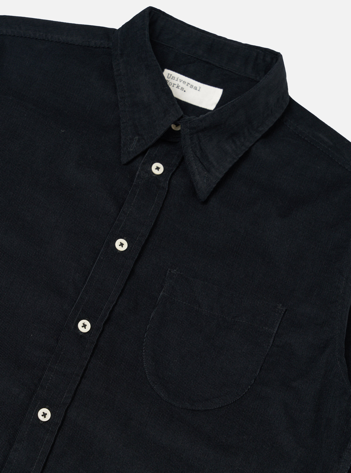 Close-up of the Black Organic Fine Cord Daybrook Shirt on a white background. The shirt features a button-down style with a chest pocket.