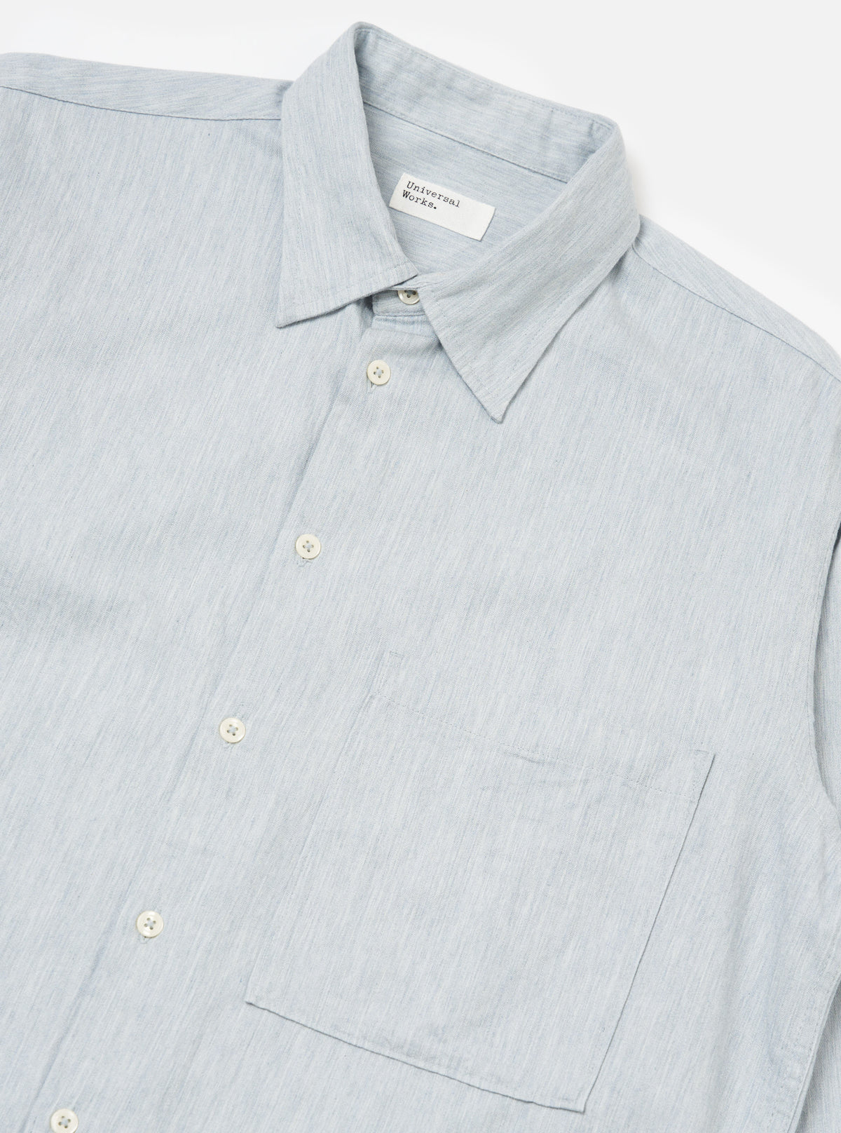 Close-up of the Sky Blue Brushed Organic Cotton Square Pocket Shirt on a white background. The shirt is buttoned, showing the collar and pocket detail.