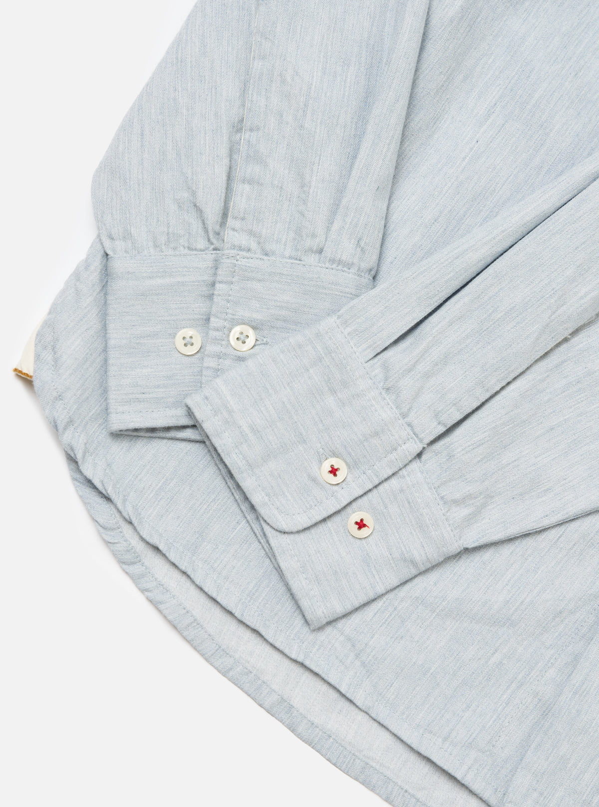 Close-up of the Sky Blue Brushed Organic Cotton Square Pocket Shirt on a white surface, showcasing the sleeve details and fabric texture.