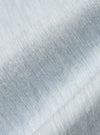 Close-up of the Sky Blue Brushed Organic Cotton Square Pocket Shirt fabric. Soft, brushed texture in a light sky blue hue. The shirt is neatly folded on a white surface.