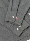Close-up of the Charcoal Organic Chambray Lucky Shirt showing the fabric texture, button details, and sleeve cuffs on a plain background.