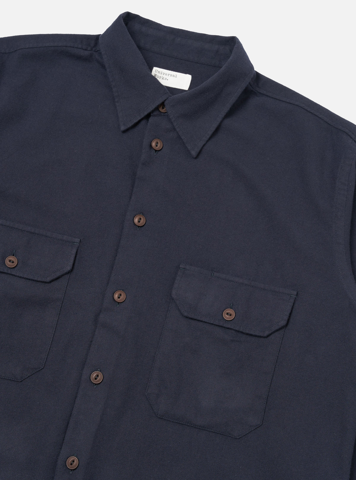 Close-up of the Dark Navy Sid Flannel CPO Shirt on a white background. The flannel shirt features two chest pockets and brown buttons.