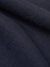 Close-up of the Dark Navy Sid Flannel CPO Shirt, showing the soft flannel texture and rich navy color. Fabric is draped to highlight the material's quality.