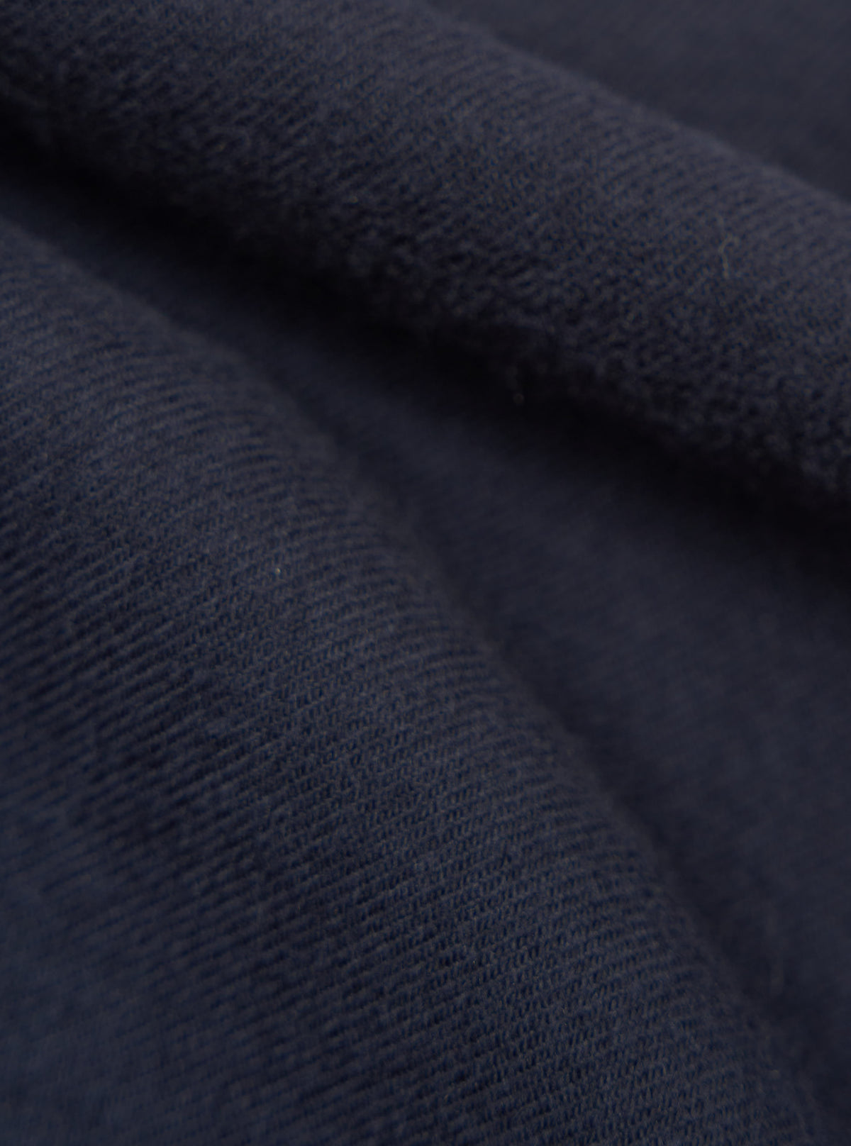 Close-up of the Dark Navy Sid Flannel CPO Shirt, showing the soft flannel texture and rich navy color. Fabric is draped to highlight the material's quality.