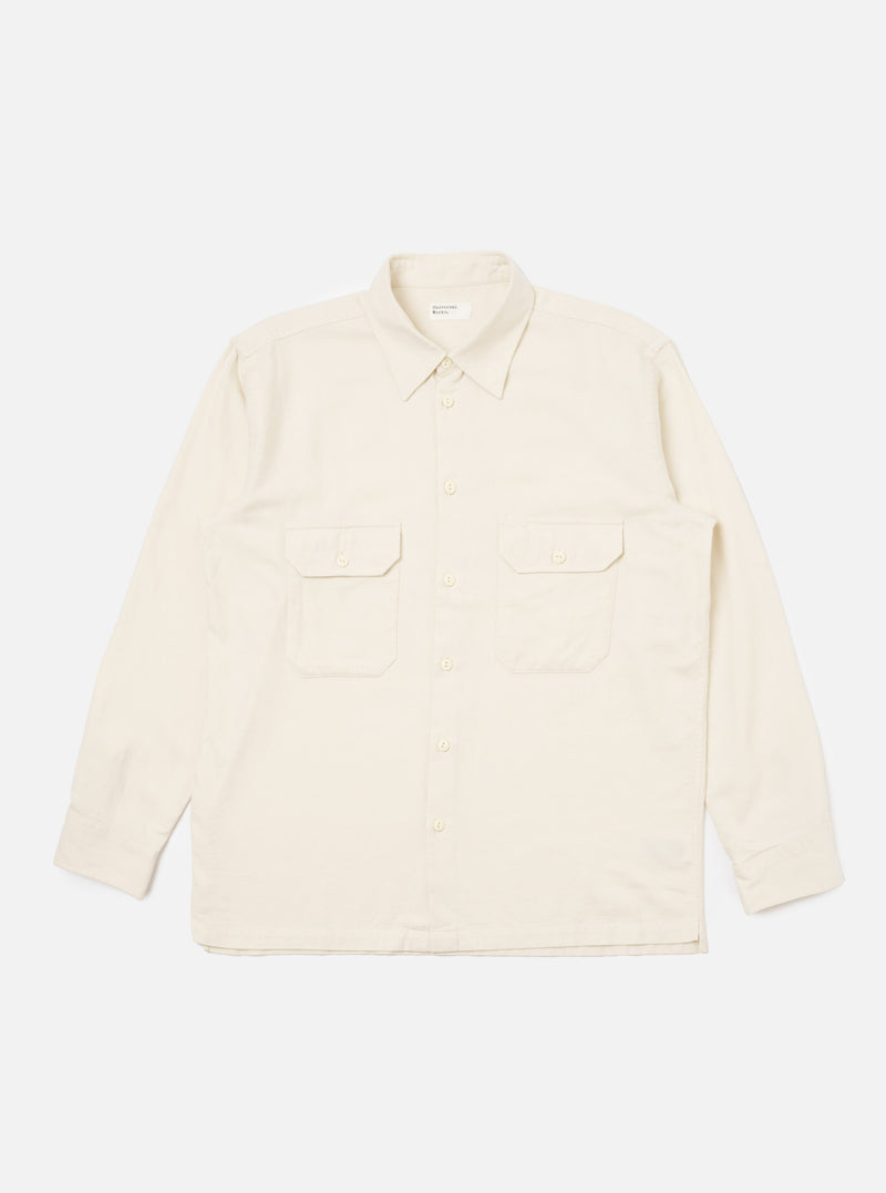 The Ecru Sid Flannel CPO Shirt in a light cream color, laid flat on a white background. The shirt has a relaxed fit, two chest pockets, and button-down closure.