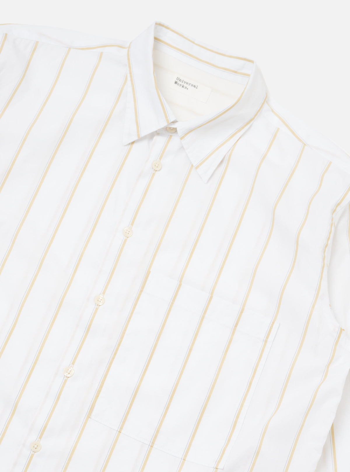 Close-up of the White Office Stripe Square Pocket Shirt on a white surface. The shirt is white with yellow stripes and has a square pocket.