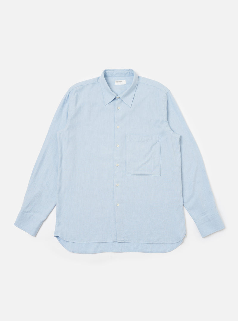 The Light Blue Brushed Marl Twill Square Pocket Shirt is displayed on a white background. The shirt is a light blue color and has a square pocket on the chest.