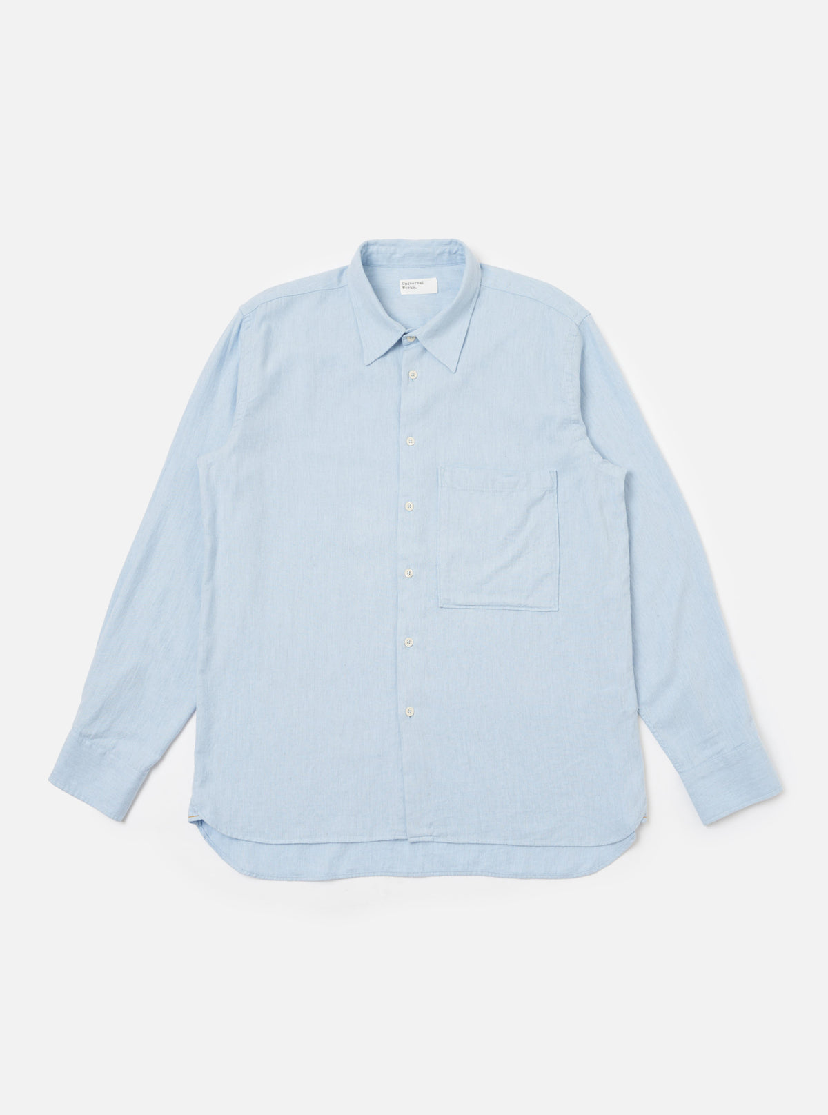 The Light Blue Brushed Marl Twill Square Pocket Shirt is displayed on a white background. The shirt is a light blue color and has a square pocket on the chest.