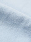 Close-up of the light blue brushed marl twill fabric of the square pocket shirt. The soft texture and subtle pattern are visible against a plain background.