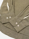 Close-up of the Mustard Brushed Marl Twill Square Pocket Shirt on a white surface. Shows the texture of the twill fabric and the button details.