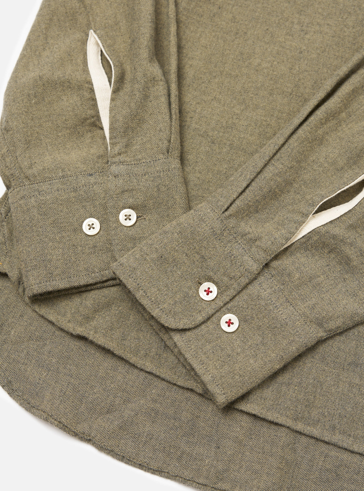 Close-up of the Mustard Brushed Marl Twill Square Pocket Shirt on a white surface. Shows the texture of the twill fabric and the button details.