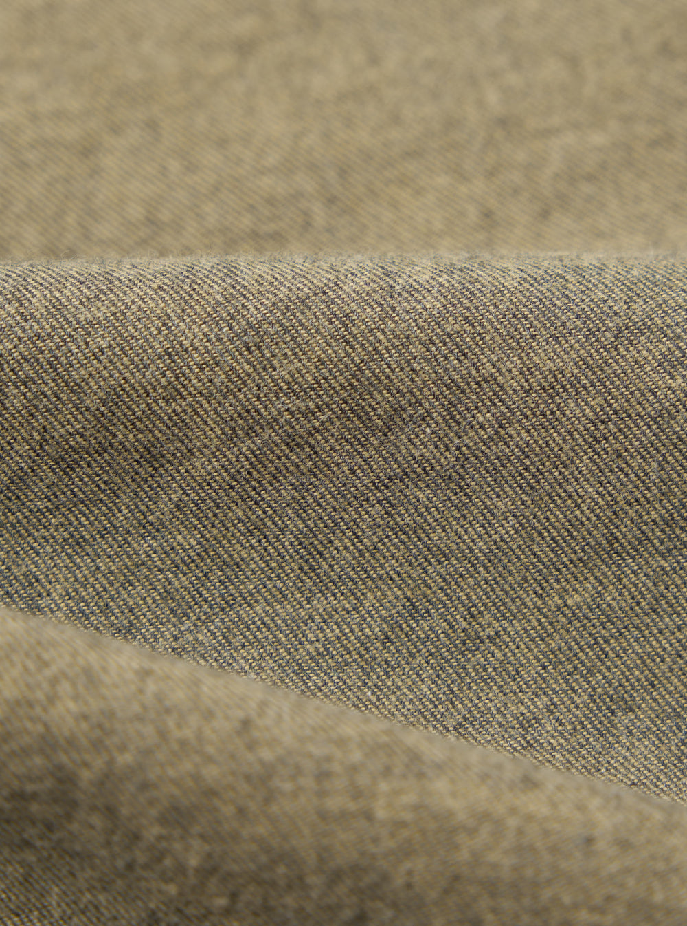 Close-up of the Mustard Brushed Marl Twill Square Pocket Shirt fabric. The twill weave is visible in shades of mustard and dark gray.