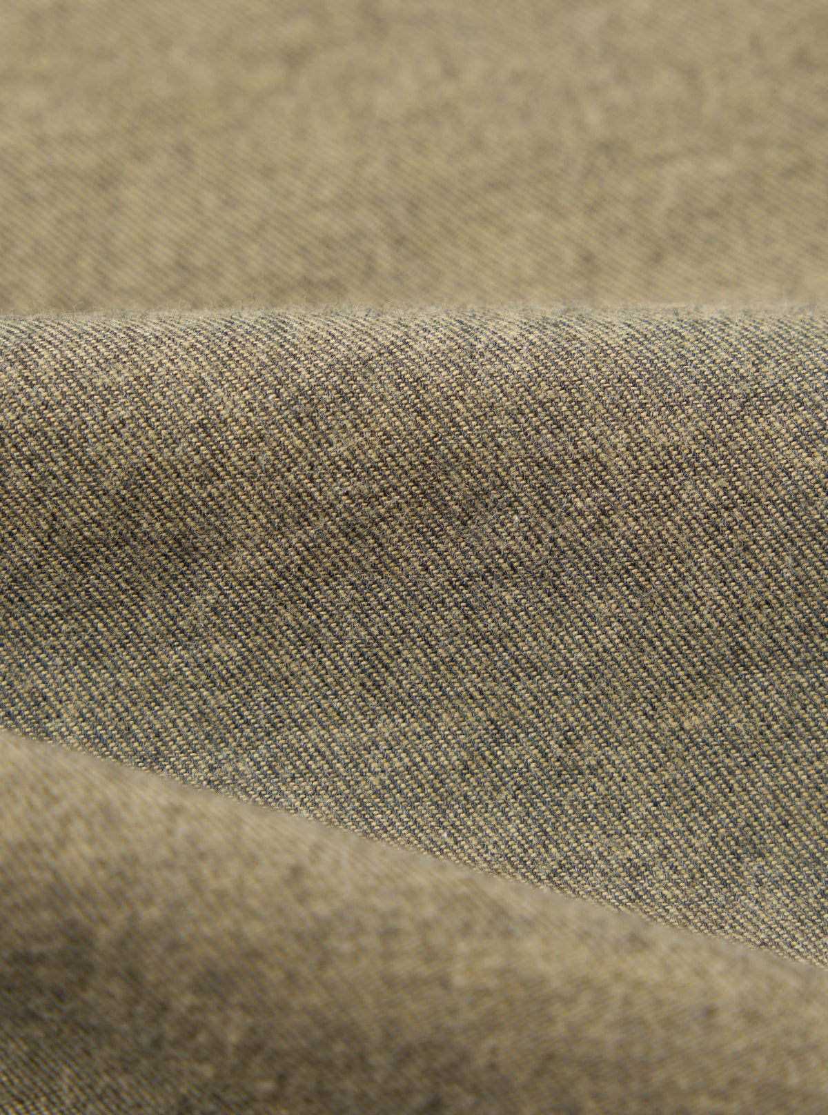 Close-up of the Mustard Brushed Marl Twill Square Pocket Shirt fabric. The twill weave is visible in shades of mustard and dark gray.