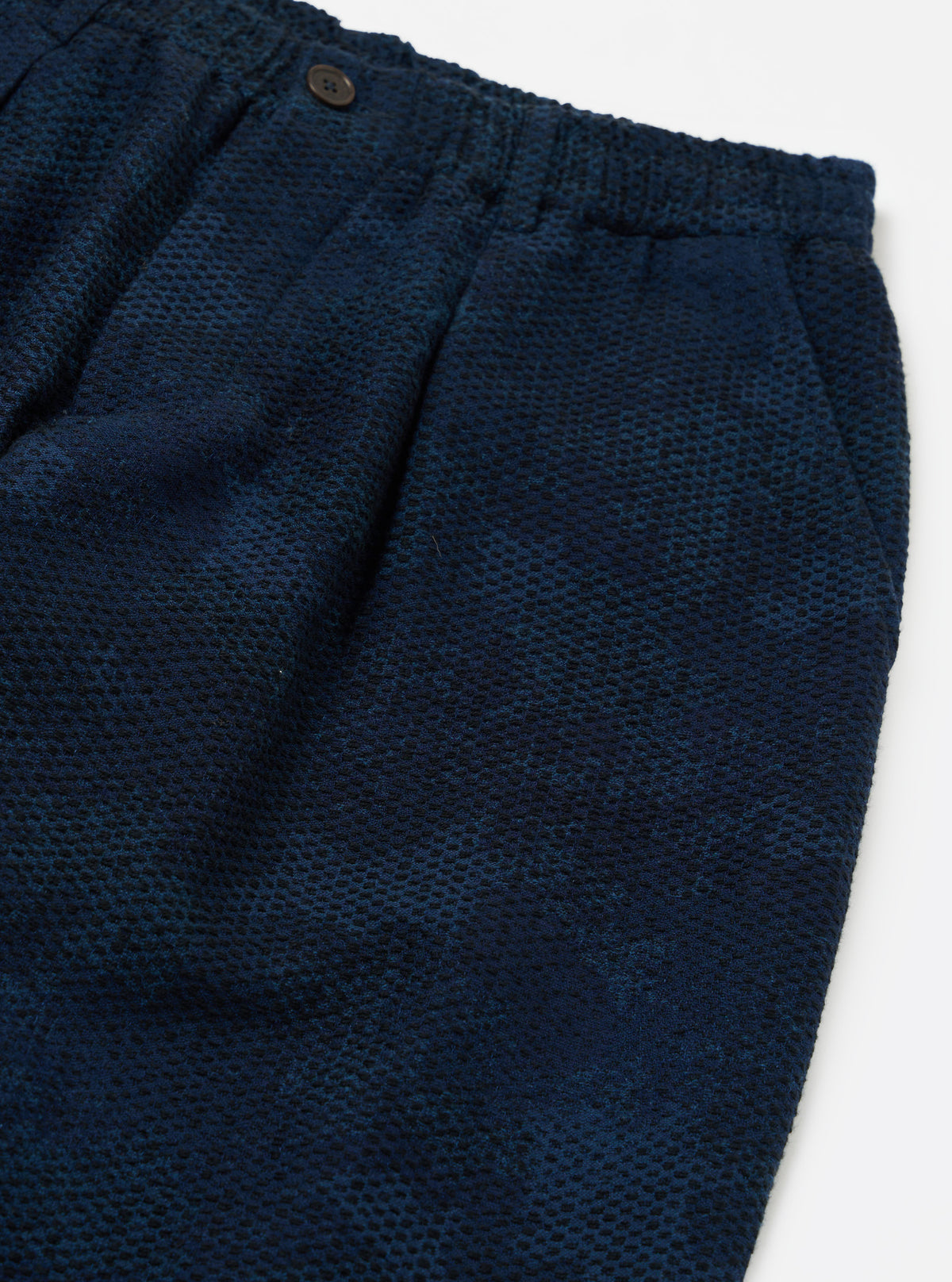 Close-up of the Black/Indigo Denim Camo Pleated Track Pant on a white background. Shows the texture and pleats of the denim.