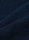 Close-up of the Black/Indigo Denim Camo Pleated Track Pant fabric. The material is a textured blend of black and indigo, creating a subtle camo effect. 