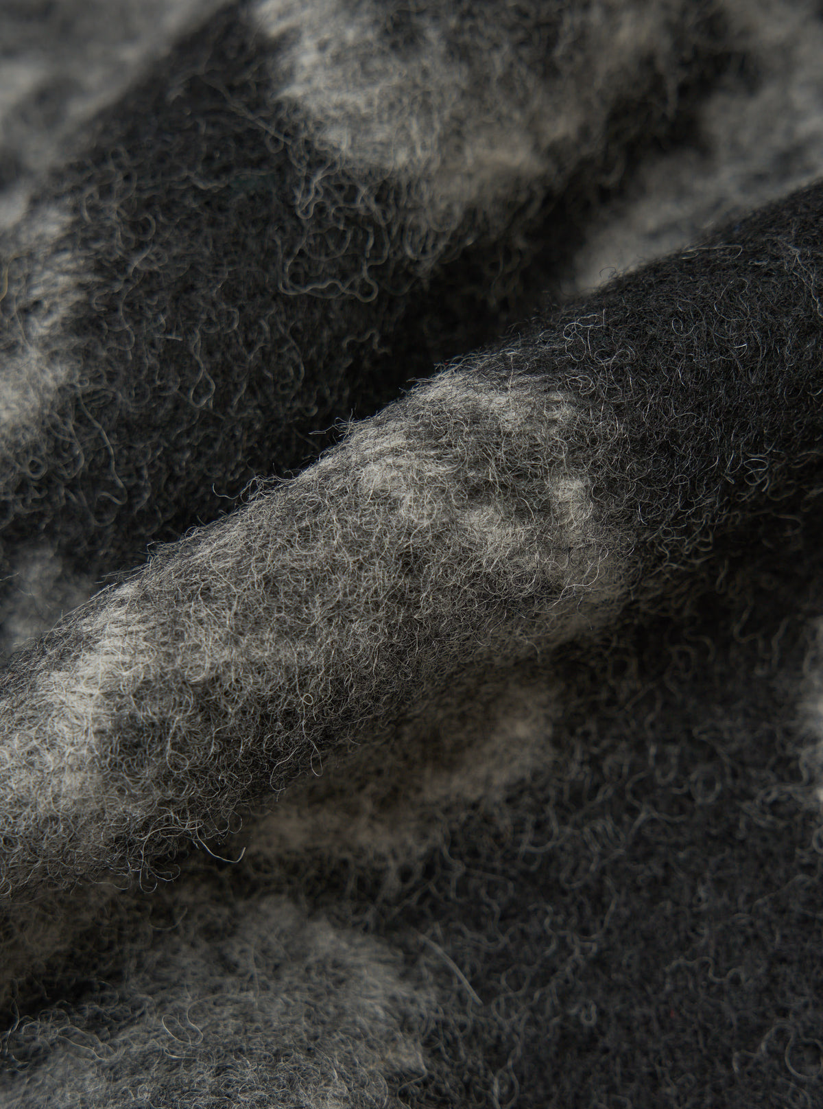 Close-up of the Charcoal Flower Fleece Zip Liner Jacket material. Soft, textured fleece in charcoal and light gray. Focus on the fabric's detail.