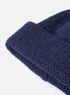 Close up of the Navy Alpaca/British Wool Bobble Hat showing the texture of the knit on a white background.