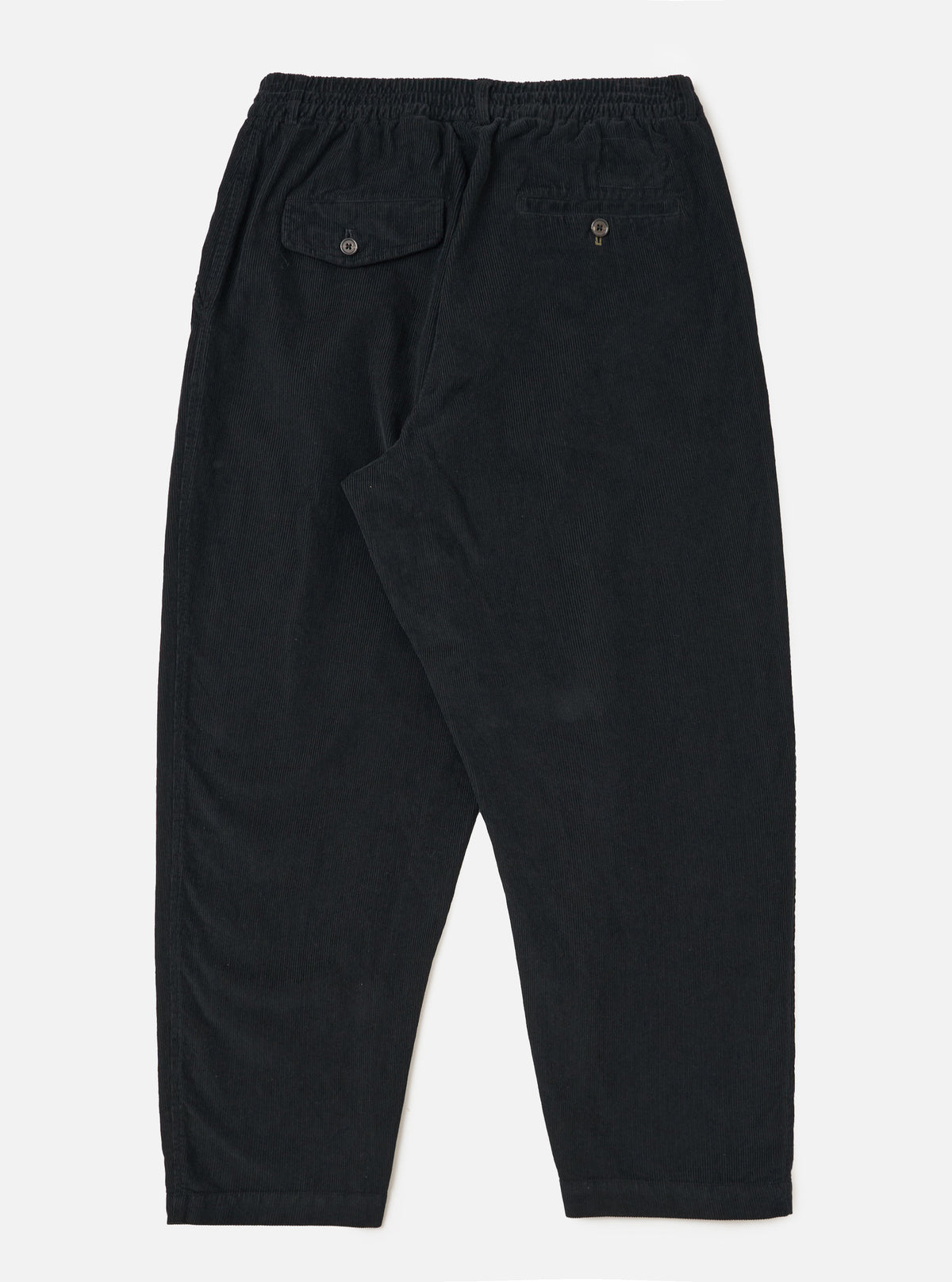 Back view of Black Cat Cord Pleated Track Pant on a white background. Shows the corduroy texture, pleated design, and relaxed fit. Features back pockets with button closures.