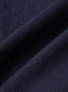 A close-up fabric swatch of the Navy Paper Touch Cotton Vacation Short displays the smooth and crisp texture of the navy blue paper-touch cotton fabric. The image focuses on the fine weave and consistent color of the material.