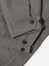 The Mid Grey Linen Slub Weave E130 Jacket is shown from the back, laid flat against a plain white background. The image highlights the textured, slubbed finish of the mid-grey linen-cotton fabric, featuring a straight hem and clean rear construction.