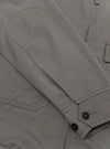 A Mid Grey Linen Slub Weave E130 Jacket is shown from the back, laid flat against a solid white background. The image highlights the straight hem, the simple construction of the back panel, and the textured appearance of the linen-cotton slub fabric.