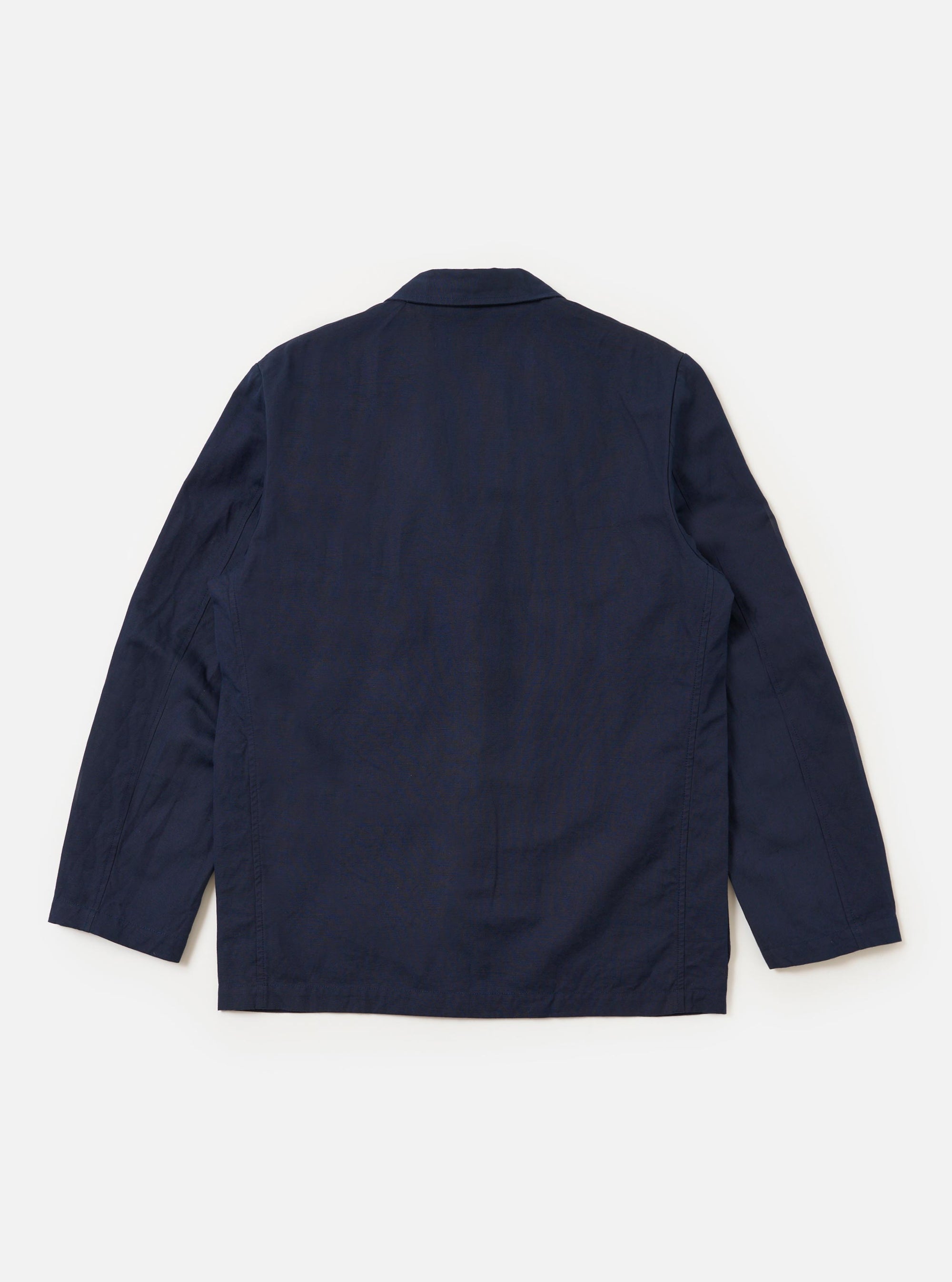 The Navy Linen Slub Weave Two Button Jacket is shown from the back, laid flat against a plain white background. The image highlights the garment's structured rear construction, including two back vents and the textured navy slub weave.