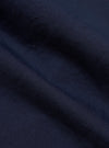 A close-up fabric swatch of the Navy Linen Slub Weave Two Button Jacket shows a detailed view of the textured, navy blue material. The image highlights the irregular slubby yarns and the character of the linen-cotton blend weave.