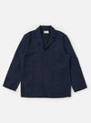 A Navy Linen Cotton Shirting Dizzy Jacket is displayed flat against a plain white background. The jacket features a classic collar, a full button-down front, and three large patch pockets on the front. The lightweight navy blue fabric has a subtle textured appearance.