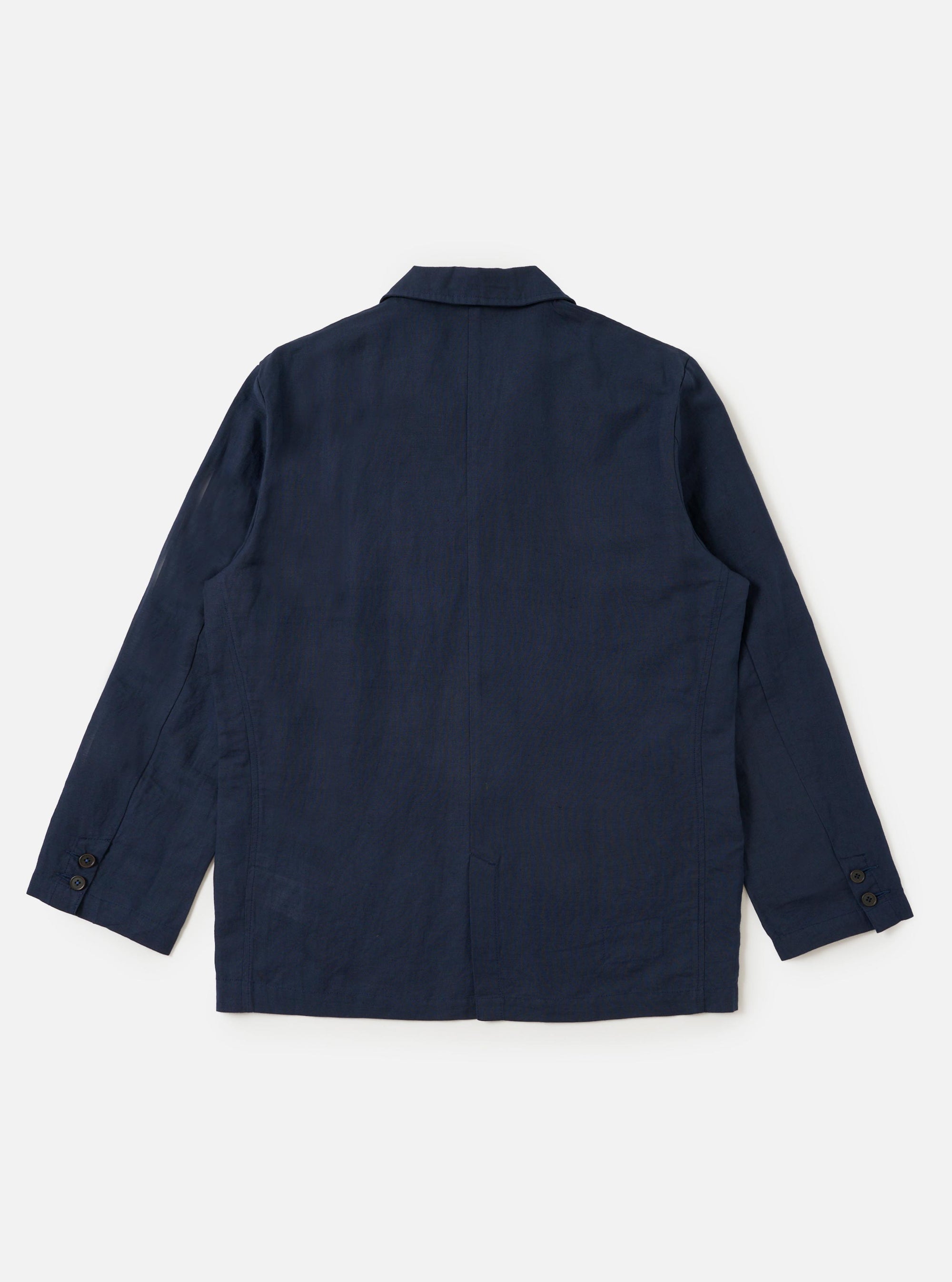 The Navy Linen Cotton Shirting Dizzy Jacket is shown from a rear perspective, laid flat against a solid white background. The image highlights the horizontal back yoke, a central vertical seam, and the straight hem of the garment. The textured navy fabric and clean stitching are clearly visible.