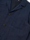 The Navy Linen Cotton Shirting Dizzy Jacket is shown from a rear perspective, laid flat against a solid white background. The image highlights the clean construction of the back, the simple collar, and the straight-cut hem of the garment.
