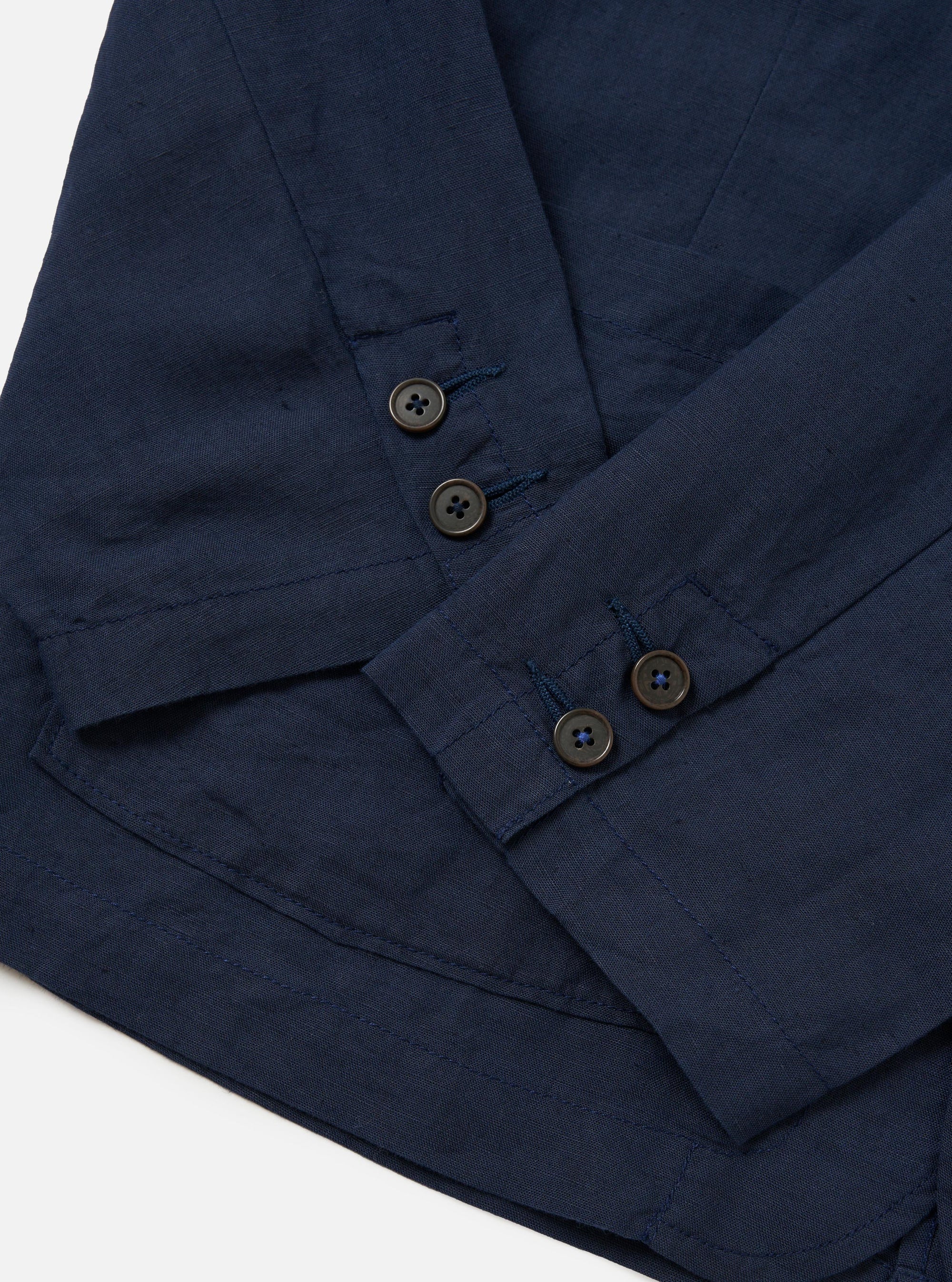 A rear view of the Navy Linen Cotton Shirting Dizzy Jacket is shown laid flat against a solid white background. The image highlights the clean construction of the back, featuring a simple straight hem and a horizontal yoke across the shoulders.