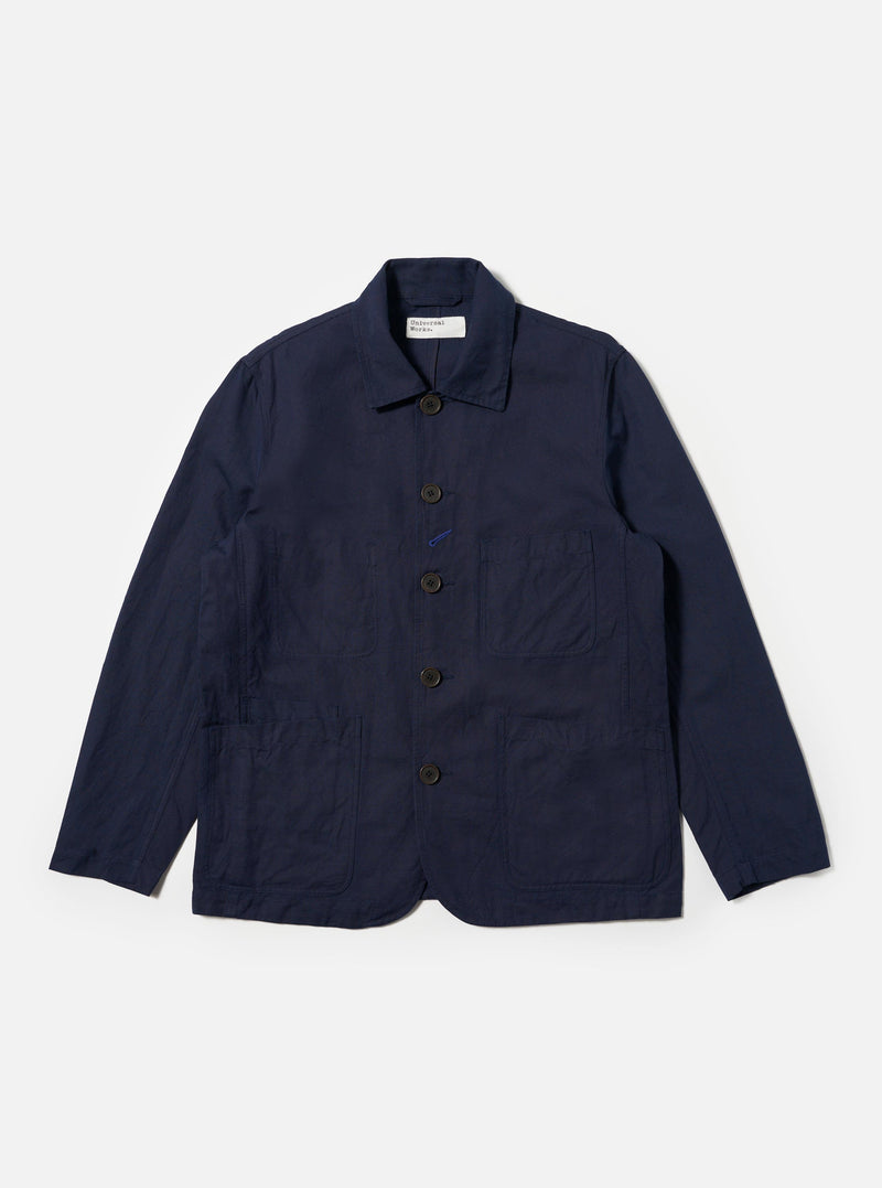 The Navy Linen Slub Weave Bakers Jacket is shown as a flat lay against a plain white background. The jacket features a five-button front closure, a notched collar, and four front patch pockets: one at the chest and three at the waist, including a smaller ticket pocket. The navy fabric has a visible textured slub weave throughout.
