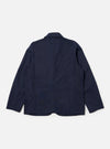 The Navy Linen Slub Weave Bakers Jacket is shown from the back, laid flat against a plain white background. The image highlights the textured navy blue slub weave fabric, a central vertical seam, and the straight hem of the garment.