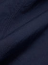 A close-up fabric swatch of the Navy Linen Slub Weave Bakers Jacket shows the deep navy blue color and the distinct, irregular texture of the linen-cotton blend. The material fills the frame to provide a detailed view of the slubbed weave.