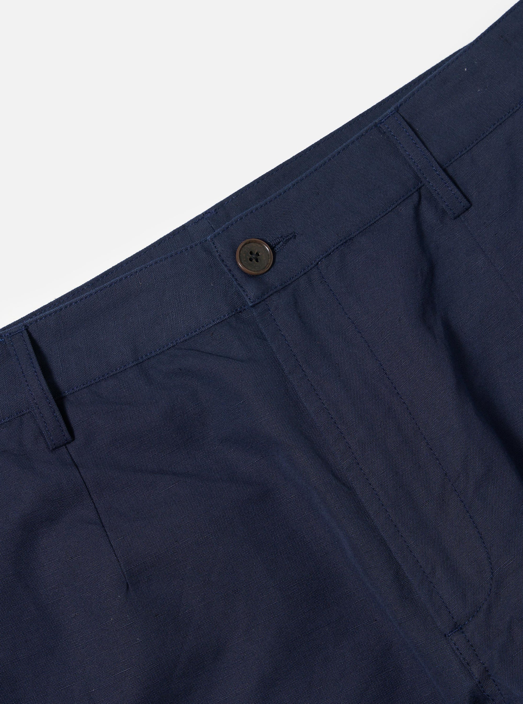 The Navy Linen Slub Weave Dizzy Trouser is shown from the rear, laid flat against a solid white background. The image highlights the wide-leg silhouette, a single rear buttoned flap pocket, and the textured slub weave of the navy fabric.
