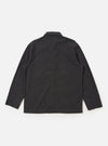 The Charcoal Seattle Cotton OG Bakers Jacket is shown from the back, laid flat against a solid white background. The image highlights the jacket's loose fit, two-piece sleeves, and a central back seam. The charcoal grey fabric features a subtle micro-textured basket weave pattern.