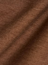 A close-up fabric swatch of the brown Meco denim used for the OG Bakers Jacket shows a detailed view of the material's texture and earthy brown color. The image focuses entirely on the weave of the recycled cotton fabric.