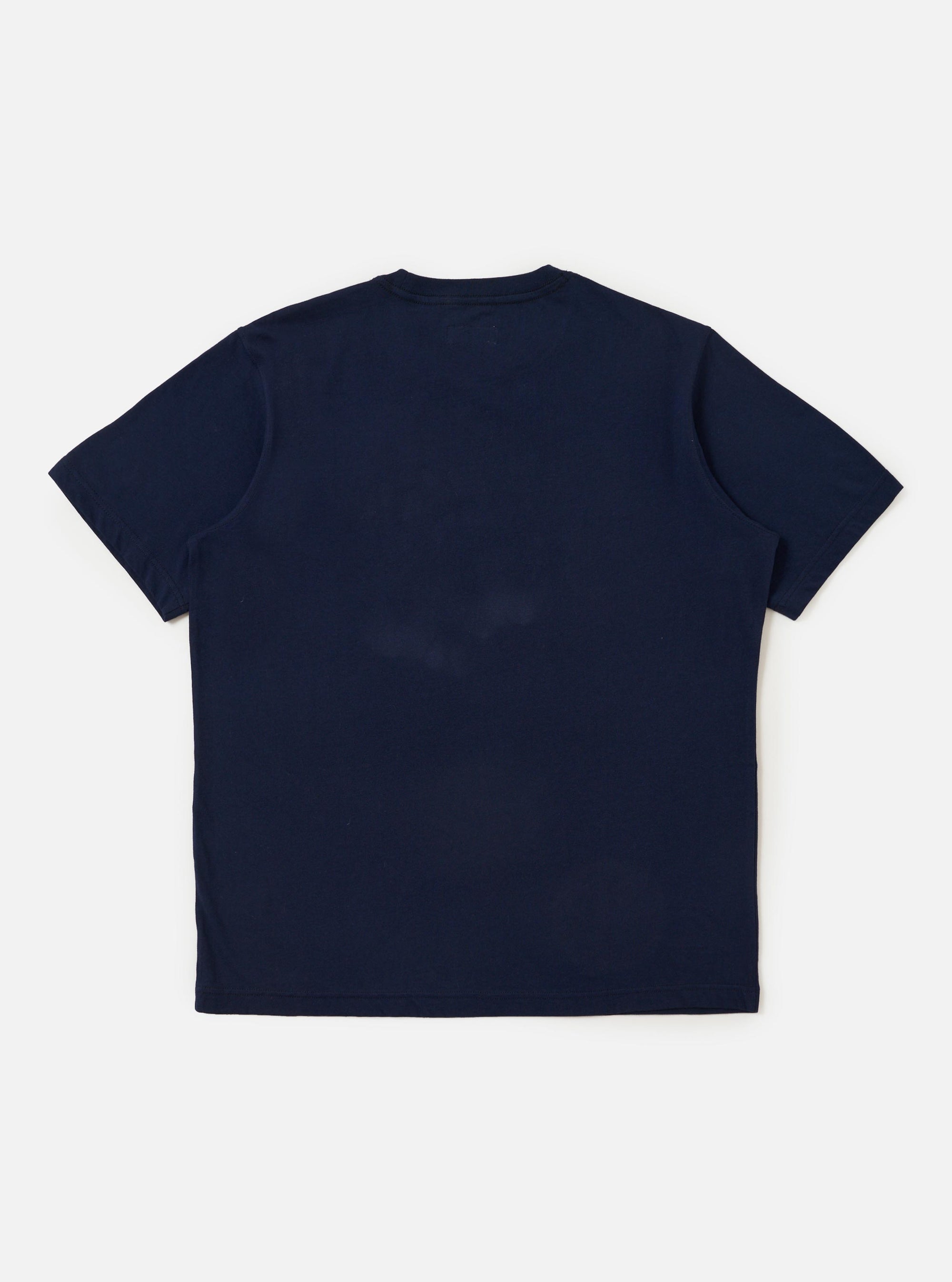 A navy single jersey T-shirt with a multi-colored graduated print is displayed flat against a plain white background. The shirt features a classic crew neck and short sleeves, with the colorful Universal Works logo printed across the chest.