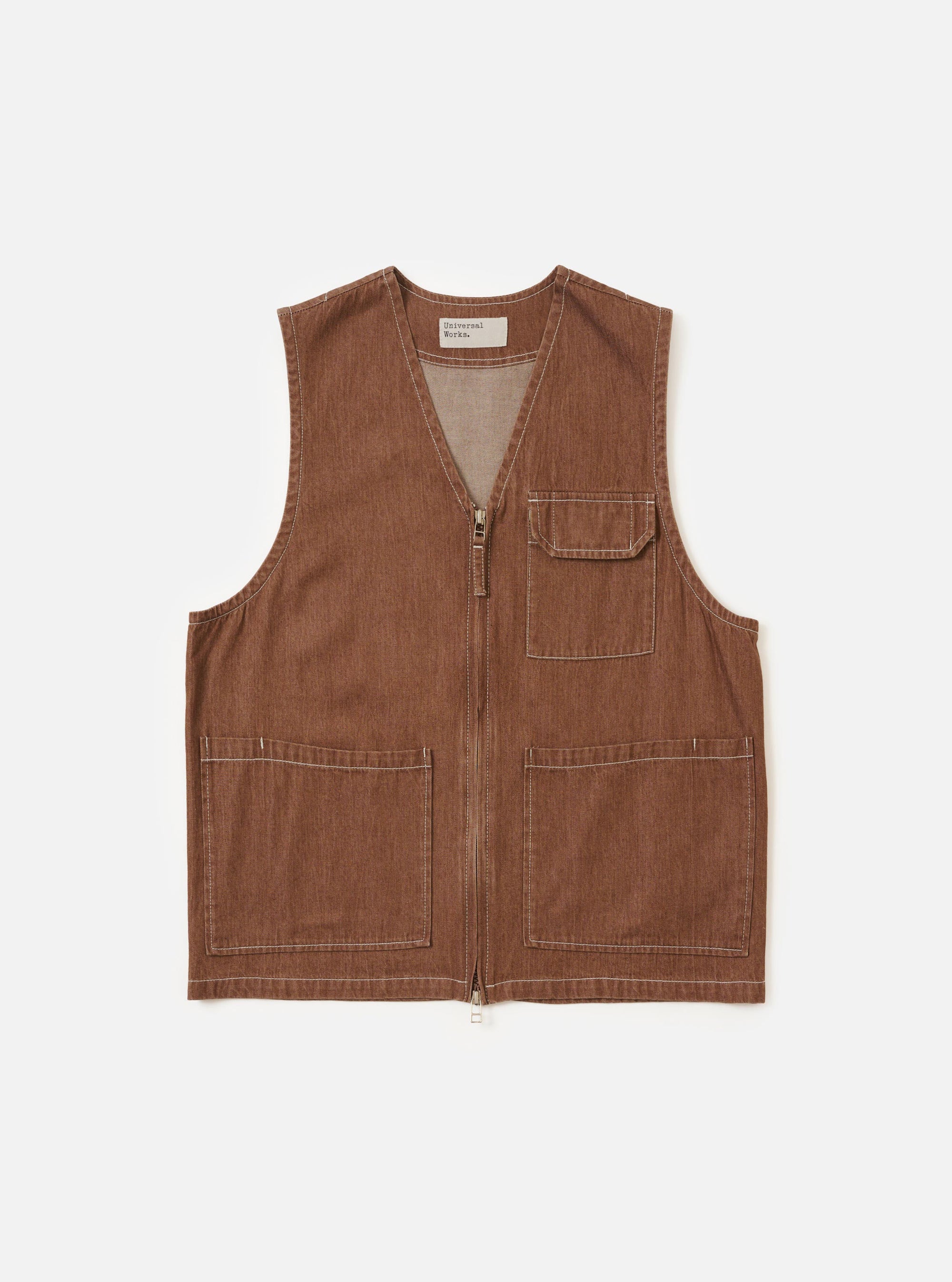 A Brown Meco Denim Marine Gilet is displayed flat against a plain white background. The garment features a button-down front, a simple v-neckline, and two large patch pockets at the waist. The brown denim fabric shows a visible texture.