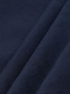 A close-up fabric swatch of the Navy Linen Slub Weave Oxford Pant displays the deep navy blue material. The image highlights the textured slub weave and the blend of linen and cotton fibers.