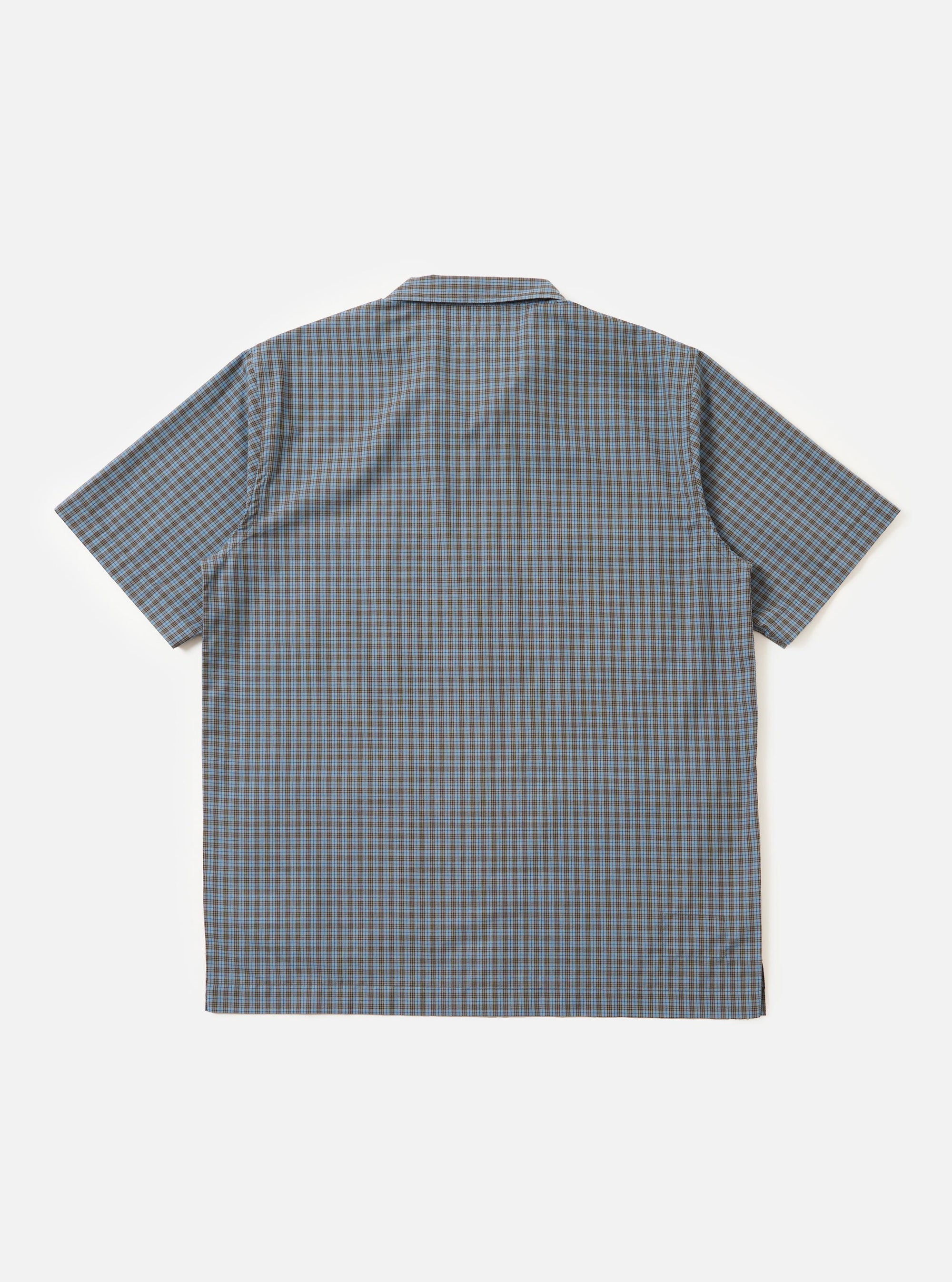 A pale blue and white check plaid summer overshirt is displayed flat against a plain white background. The garment features a pointed collar, a full button-down front, and two large patch pockets on the chest.