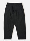 A pair of Black Broadcloth Oxford Pants is shown laid flat against a solid white background. The trousers feature a wide-leg silhouette with a single pleat on each leg and an elasticated waistband with a visible tonal drawstring. Key details include side slip pockets and a buttoned waistband.