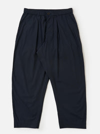A pair of navy blue cotton broadcloth Oxford pants is displayed flat against a plain white background. The trousers feature a wide leg with a slight taper, a single front pleat, and an elasticated waistband with a white drawstring.