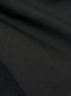 A close-up fabric swatch of the black broadcloth material used for the Camp Shirt. The image displays the tight weave and smooth texture of the solid black fabric.